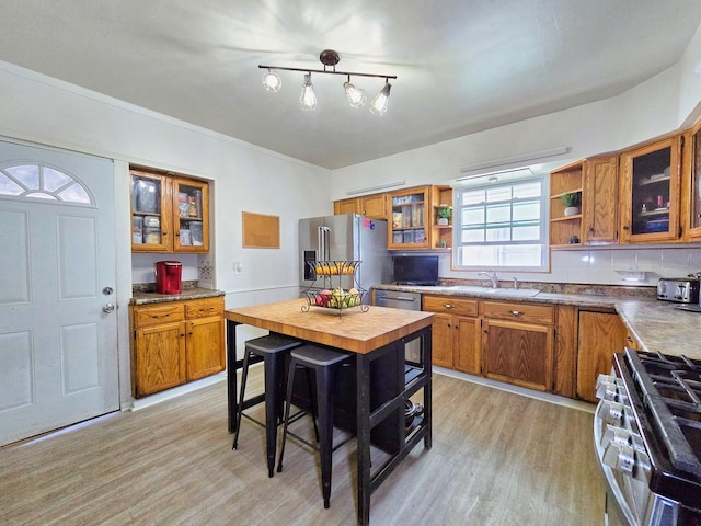 3715 Clinton Ave, Berwyn, IL 60402 - kitchen with stainless steel appliances, brown cabinets, a sink, open shelves, and light wood-style flooring