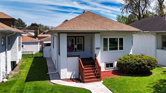 3715 Clinton Ave, Berwyn, IL 60402 - bungalow with a shingled roof, a front yard, covered porch, and stucco siding