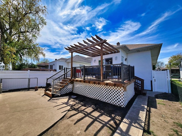 3715 Clinton Ave, Berwyn, IL 60402 - rear view of property with a wooden deck, fence, a gate, and stucco siding