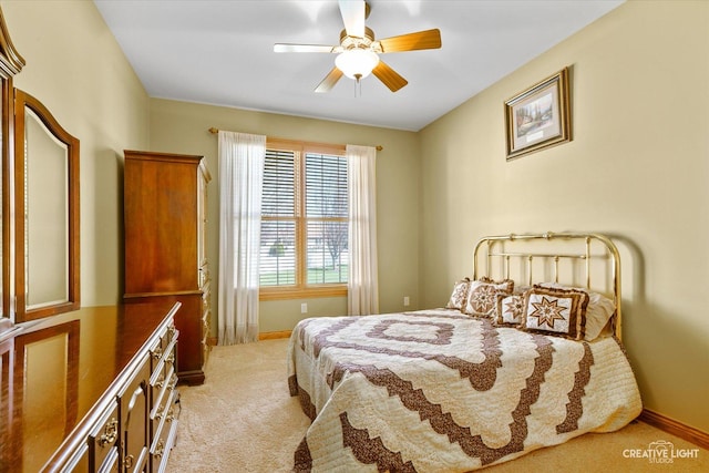 carpeted bedroom featuring baseboards and ceiling fan