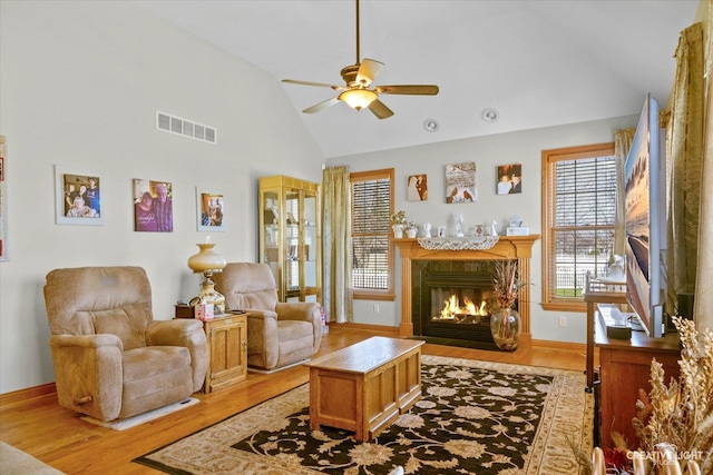 living area featuring visible vents, light wood finished floors, and plenty of natural light