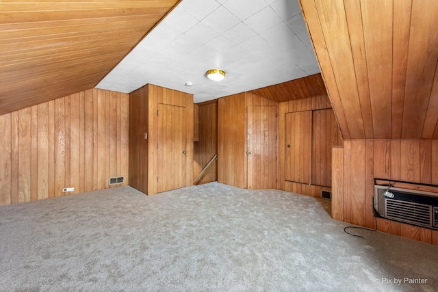 bonus room featuring wood walls, vaulted ceiling, visible vents, and carpet floors