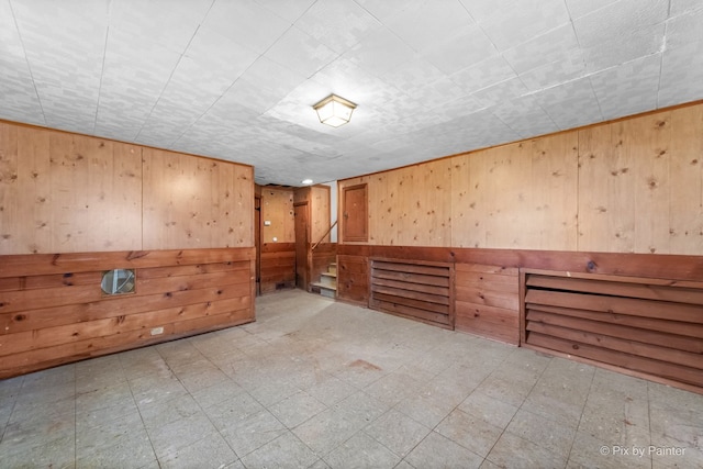 finished basement with wooden walls and light floors