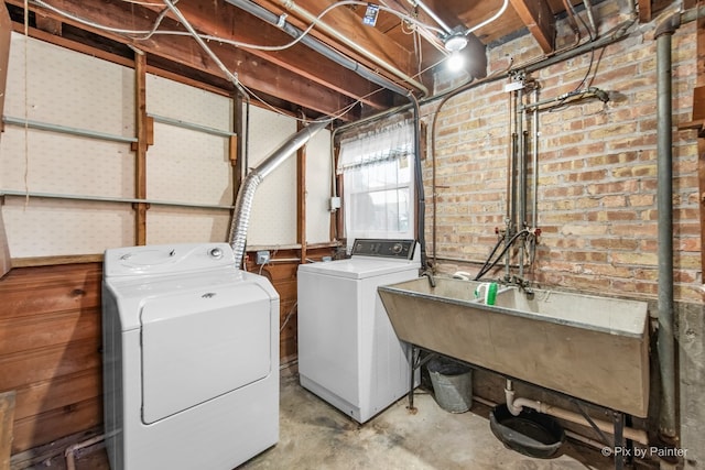 laundry area featuring a sink, washer and clothes dryer, and laundry area