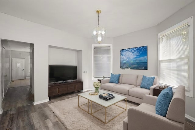 6611 S Peoria St, Chicago, IL 60621 - living area with dark wood-style flooring, baseboards, and a chandelier