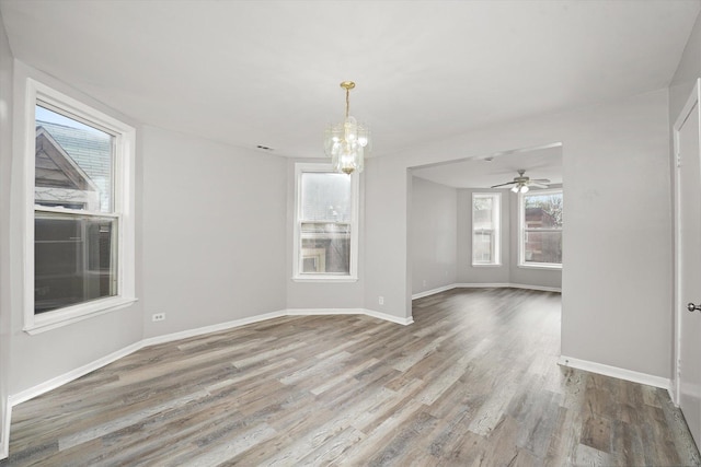 6611 S Peoria St, Chicago, IL 60621 - unfurnished dining area with a chandelier, wood finished floors, baseboards, and ceiling fan