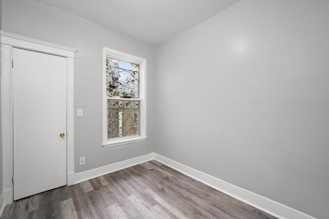 6611 S Peoria St, Chicago, IL 60621 - empty room with dark wood-type flooring and baseboards