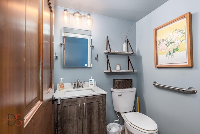 half bathroom featuring vanity and toilet