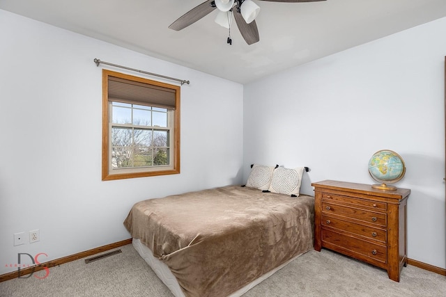bedroom featuring visible vents, baseboards, a ceiling fan, and light colored carpet