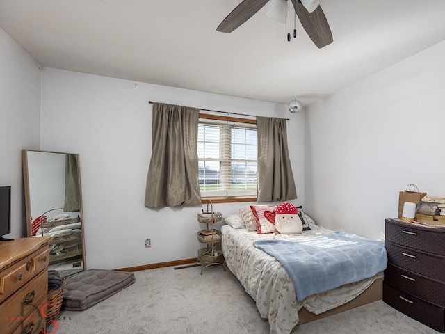 bedroom with light carpet, baseboards, and ceiling fan