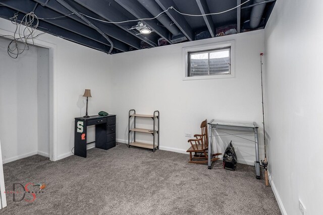 below grade area featuring baseboards and carpet