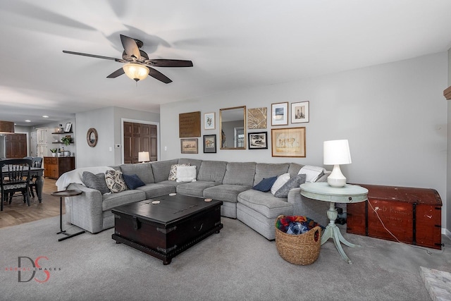 living area featuring a ceiling fan