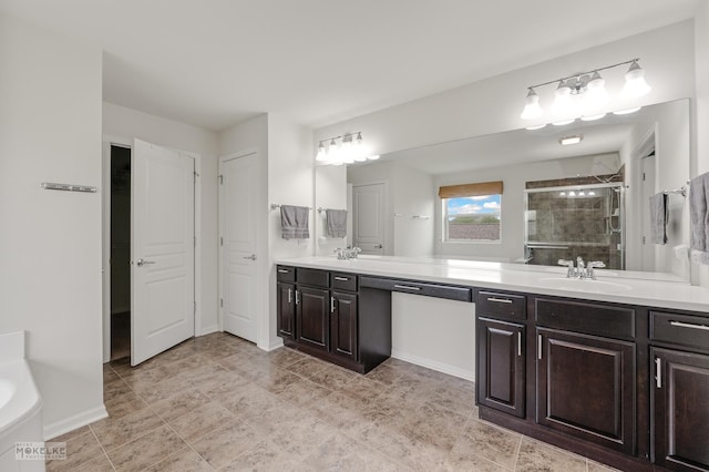 bathroom featuring a sink, a bath, a stall shower, and double vanity