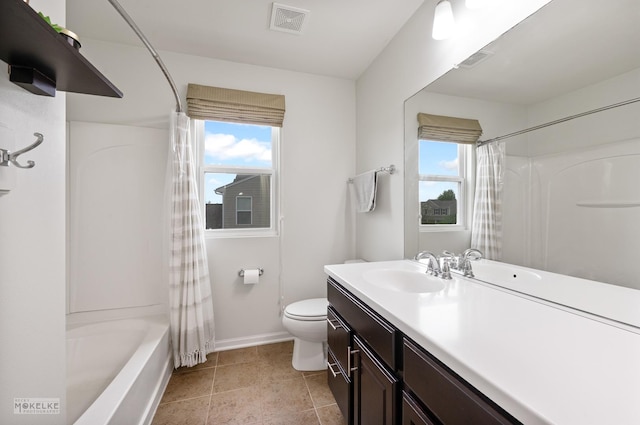 bathroom featuring toilet, baseboards, visible vents, and plenty of natural light