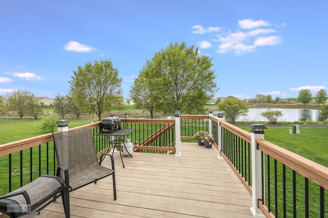 wooden deck featuring a water view and a yard