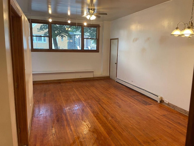 2500 Clarence Ave, Berwyn, IL 60402 - spare room featuring ceiling fan with notable chandelier, rail lighting, baseboard heating, baseboards, and hardwood / wood-style flooring