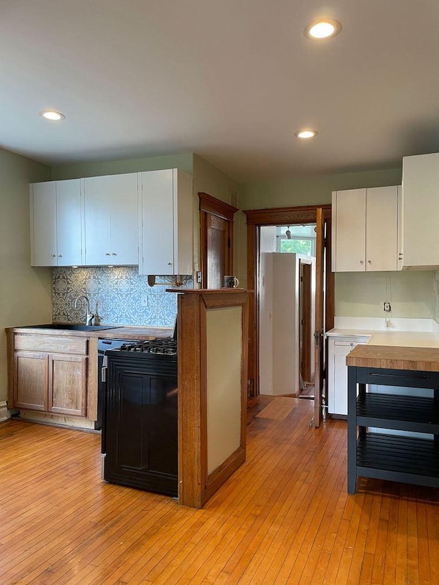 2500 Clarence Ave, Berwyn, IL 60402 - kitchen featuring tasteful backsplash, light wood-type flooring, recessed lighting, and a sink