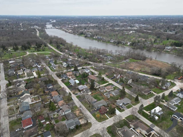 aerial view of property's location with a nearby body of water and nearby suburban area
