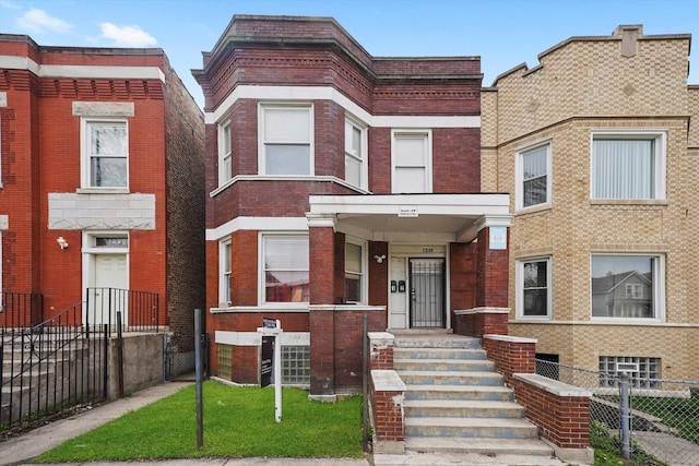 multi unit property featuring brick siding and fence