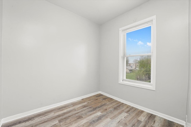 empty room featuring baseboards and wood finished floors