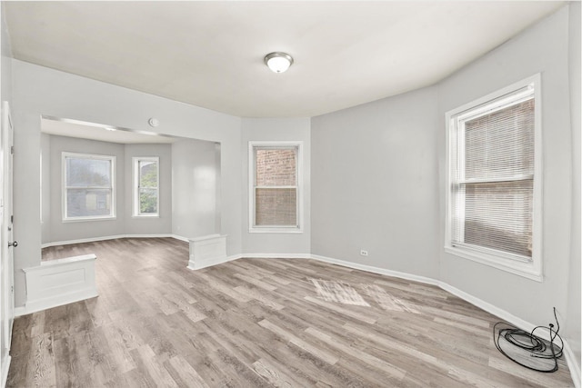 interior space featuring light wood-style flooring and baseboards