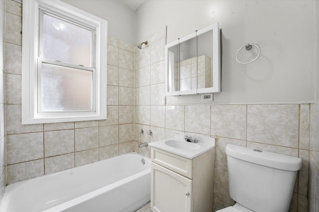 bathroom featuring shower / bathing tub combination, toilet, tile walls, vanity, and plenty of natural light