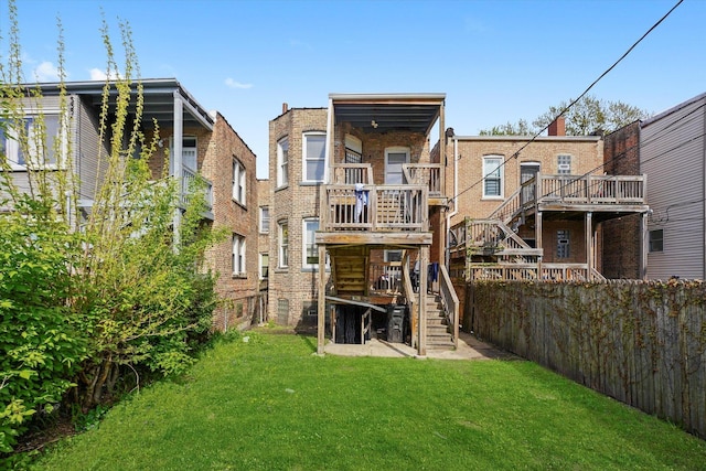 back of house featuring stairs, brick siding, and a lawn
