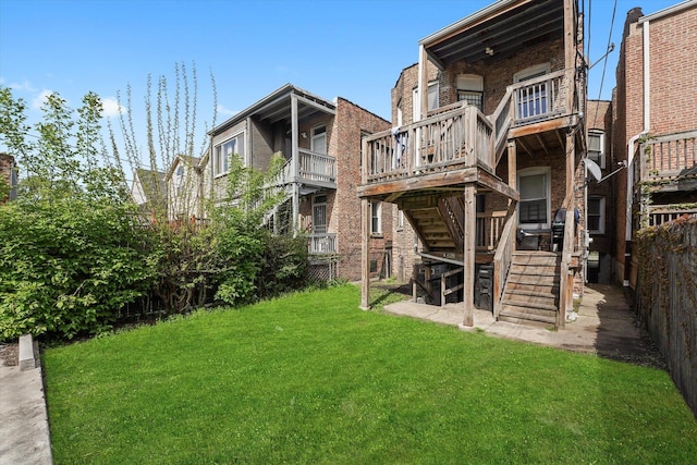 view of yard with stairway, a wooden deck, and fence
