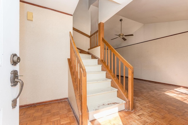 stairs featuring high vaulted ceiling, baseboards, and a ceiling fan