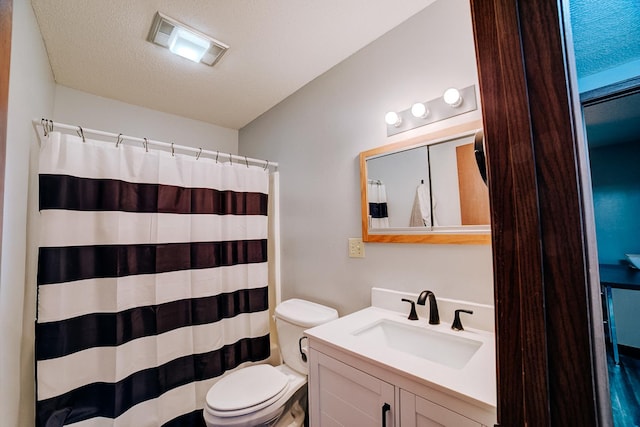 bathroom featuring vanity, curtained shower, a textured ceiling, toilet, and visible vents