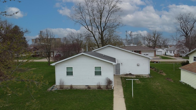 view of side of home featuring a lawn