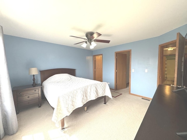 bedroom with a ceiling fan, visible vents, and light colored carpet