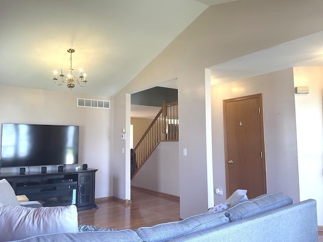 living room featuring stairway, vaulted ceiling, visible vents, a notable chandelier, and dark wood-style floors
