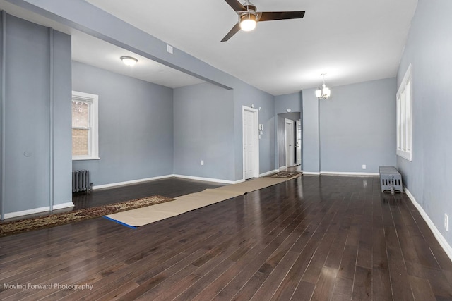 11945 S State St, Chicago, IL 60628 - unfurnished living room with baseboards, radiator, ceiling fan with notable chandelier, and wood finished floors