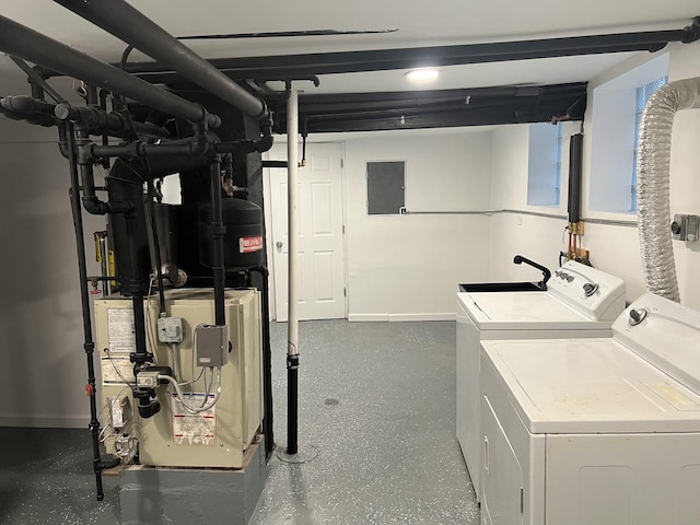 11945 S State St, Chicago, IL 60628 - laundry area featuring laundry area, washer and clothes dryer, baseboards, and a heating unit