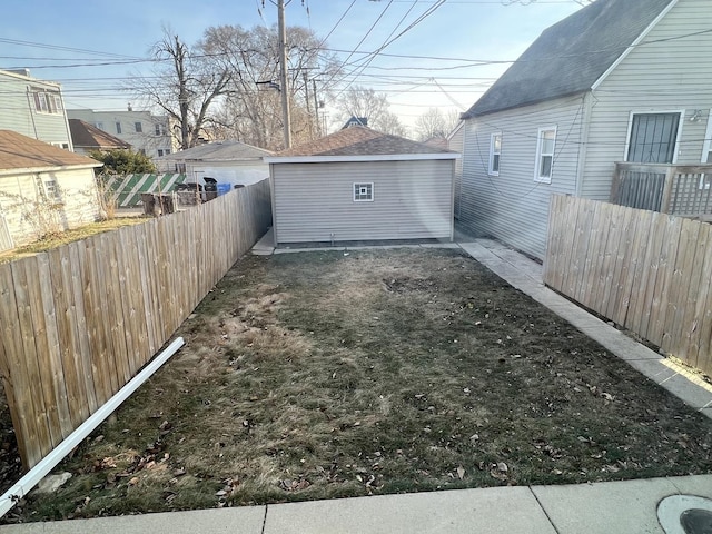 11945 S State St, Chicago, IL 60628 - view of yard with an outdoor structure and a fenced backyard