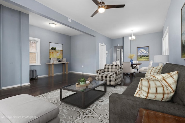 11945 S State St, Chicago, IL 60628 - living room featuring baseboards, radiator, ceiling fan with notable chandelier, and wood finished floors