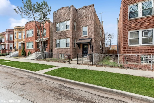 7204 S Cornell Ave, Chicago, IL 60649 - multi unit property featuring a fenced front yard and brick siding