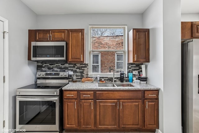 7204 S Cornell Ave, Chicago, IL 60649 - kitchen with a sink, decorative backsplash, light stone counters, and stainless steel appliances