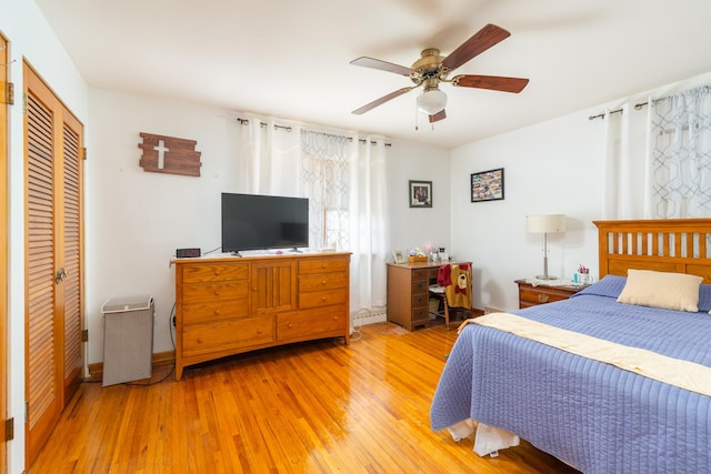 bedroom with light wood finished floors, a closet, and ceiling fan