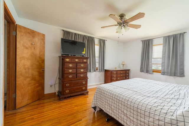 bedroom with baseboards, ceiling fan, and wood finished floors