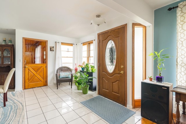 entryway with light tile patterned floors and baseboards