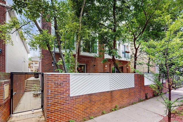 1341 N Wolcott Ave Unit A, Chicago, IL 60622 - view of property exterior with brick siding and a gate