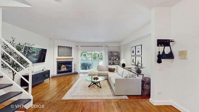 1341 N Wolcott Ave Unit A, Chicago, IL 60622 - living room with wood finished floors, stairs, a glass covered fireplace, and recessed lighting