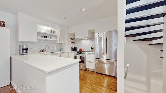 1341 N Wolcott Ave Unit A, Chicago, IL 60622 - kitchen featuring appliances with stainless steel finishes, tasteful backsplash, white cabinetry, a peninsula, and recessed lighting