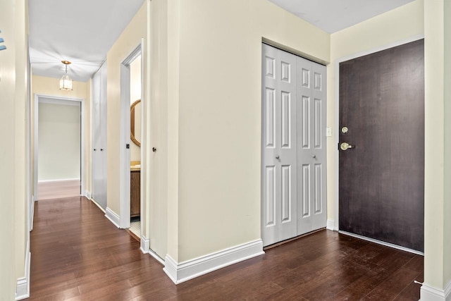 foyer entrance featuring wood finished floors and baseboards