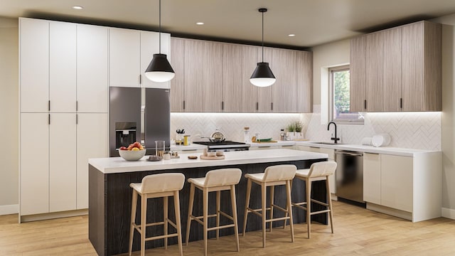 944 Beloit Ave Unit 5, Forest Park, IL 60130 - kitchen with appliances with stainless steel finishes, a sink, decorative backsplash, an island with sink, and recessed lighting