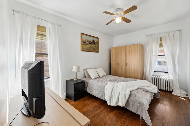 3418 N Oak Park Ave, Chicago, IL 60634 - bedroom featuring multiple windows, a ceiling fan, radiator, and wood finished floors