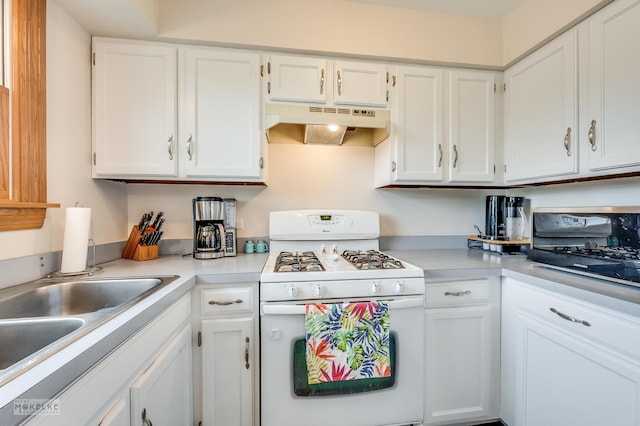 kitchen featuring light countertops, white cabinets, white range with gas stovetop, and under cabinet range hood