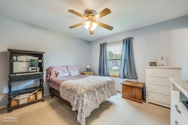 bedroom with a ceiling fan and light colored carpet